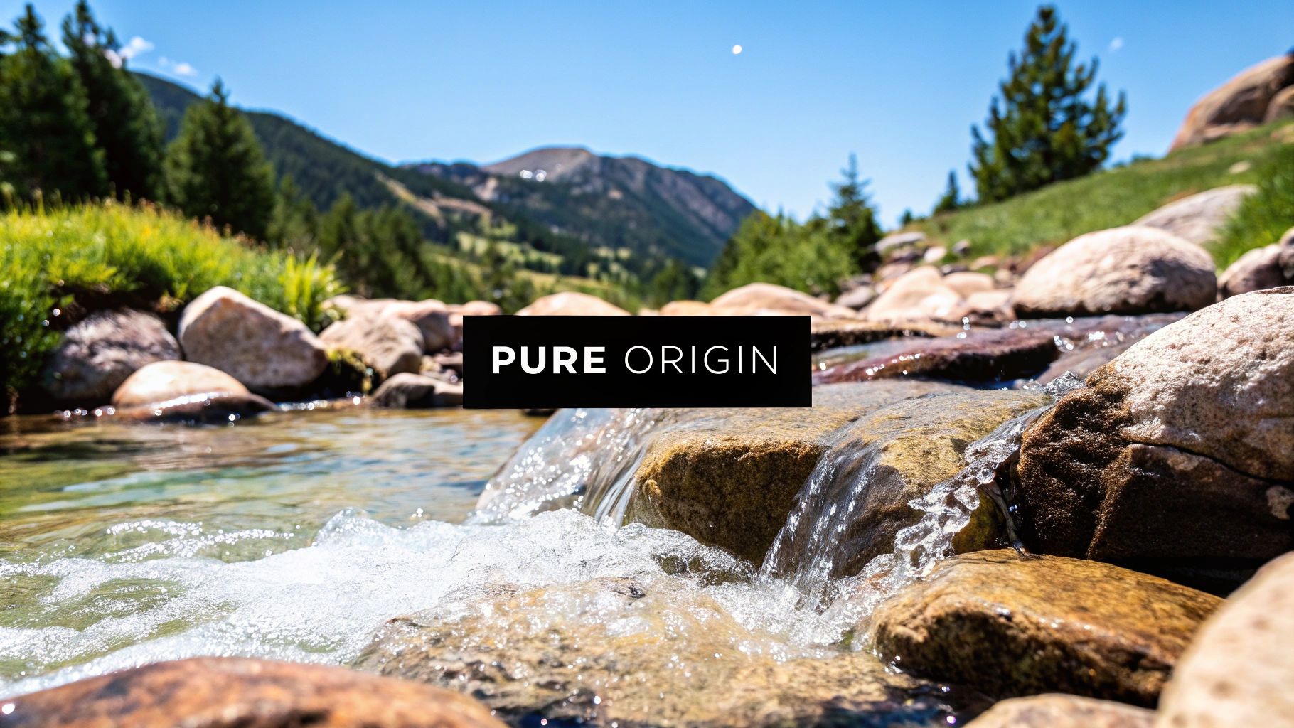 Clear stream flowing over rocks with mountains and trees in the background under a blue sky. Text reads "Pure Origin" in the center.