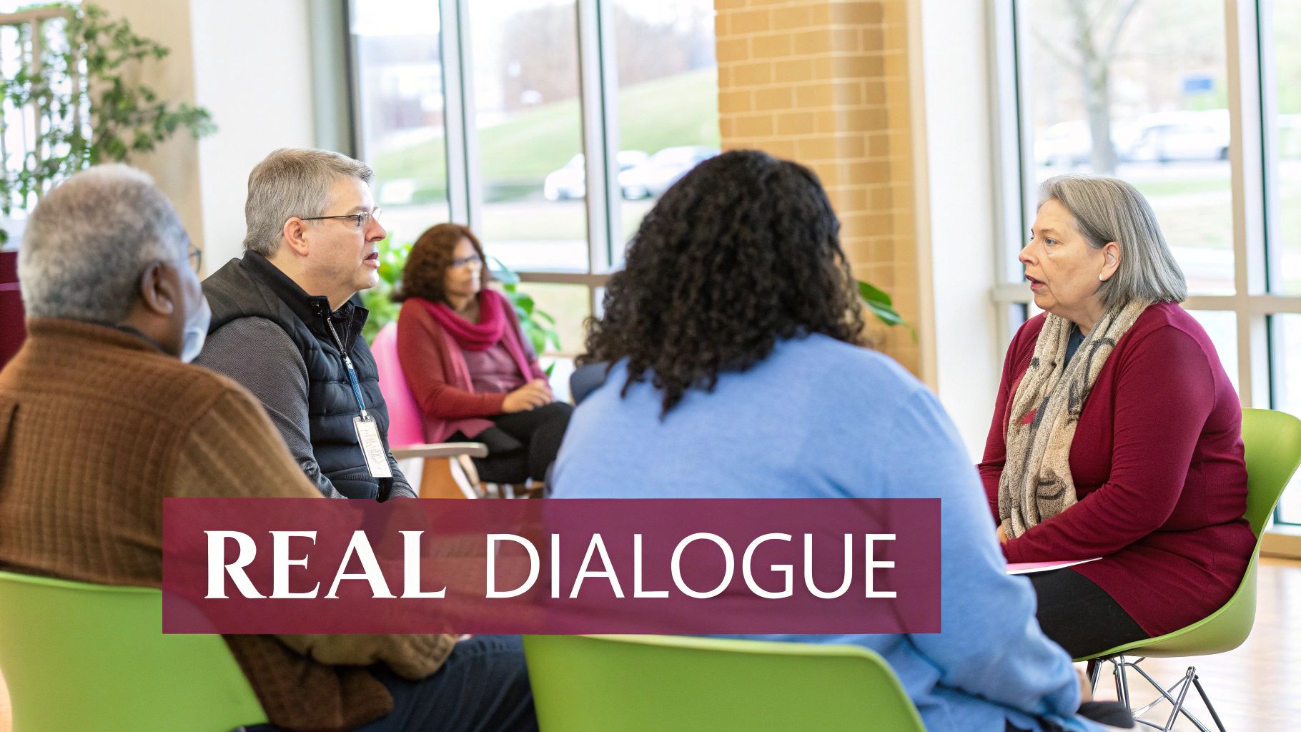 A group of City of Jenks diverse people sit in a circle, engaged in discussion. Text reads "REAL DIALOGUE." Bright, airy room with large windows.