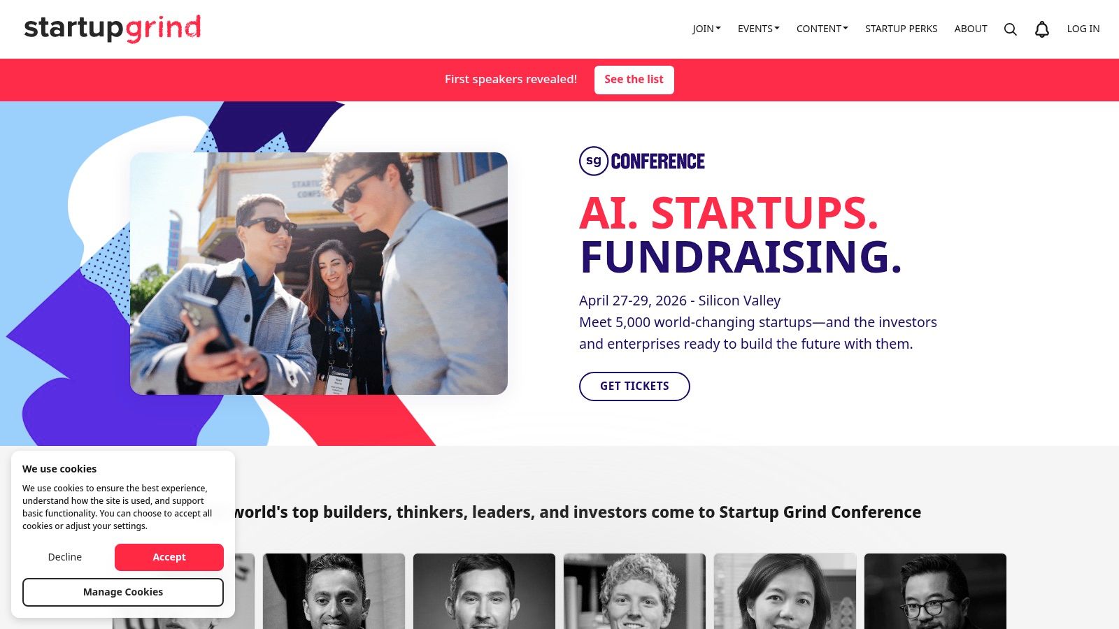 A diverse group of entrepreneurs engaged in a panel discussion at a Startup Grind conference, with an attentive audience in the foreground.