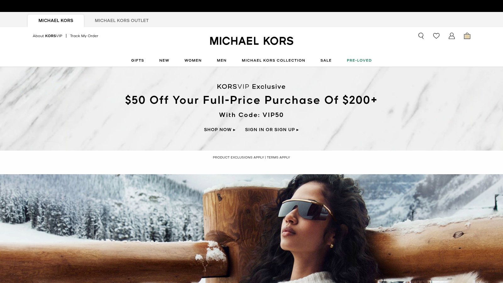 A display of Michael Kors handbags and accessories inside a brightly lit retail store, showcasing the brand's signature style.