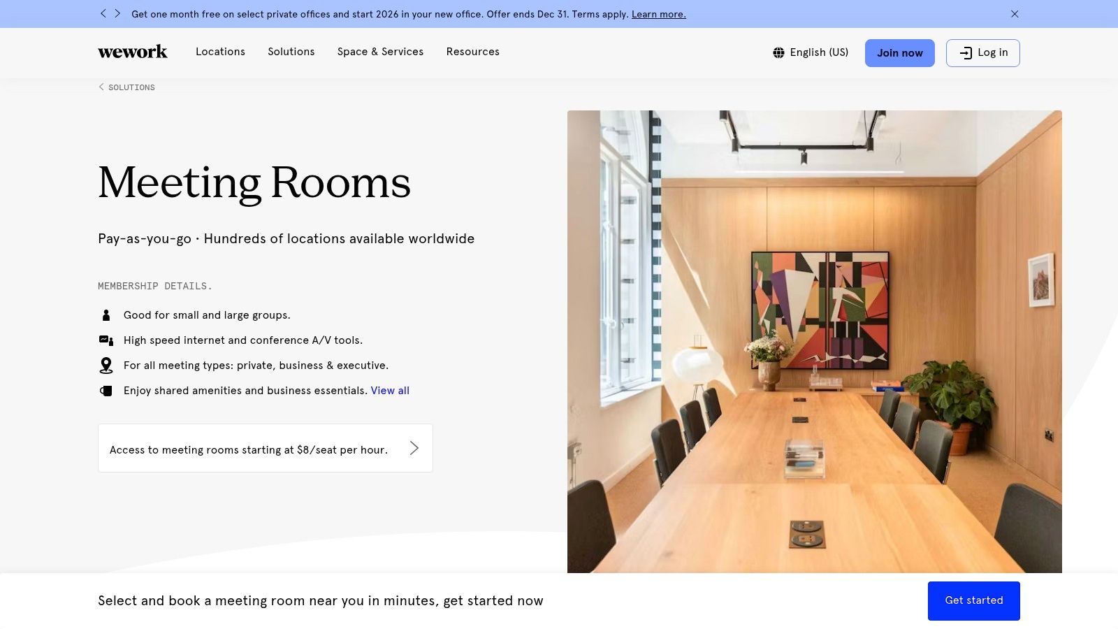 A modern WeWork meeting room with a large screen, whiteboard, and comfortable seating, ideal for presentations.