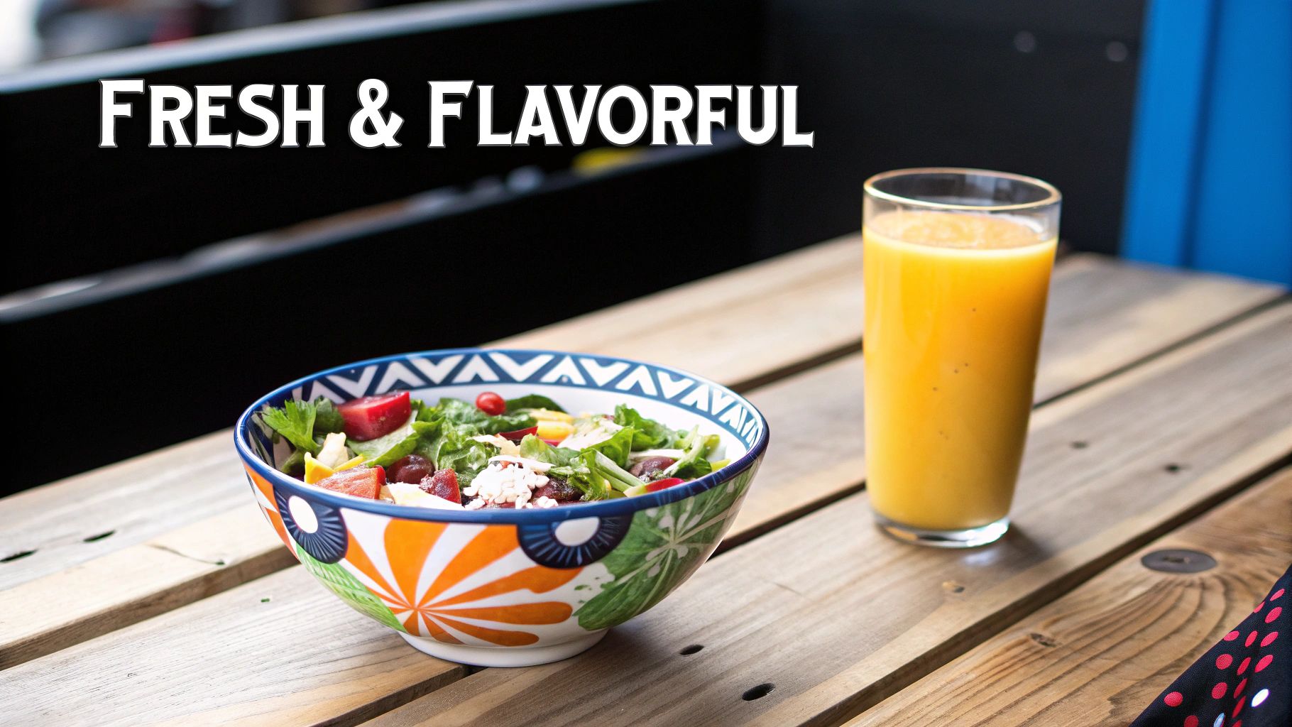 A vibrant salad bowl and fresh orange juice on a wooden table, with "FRESH & FLAVORFUL" text.
