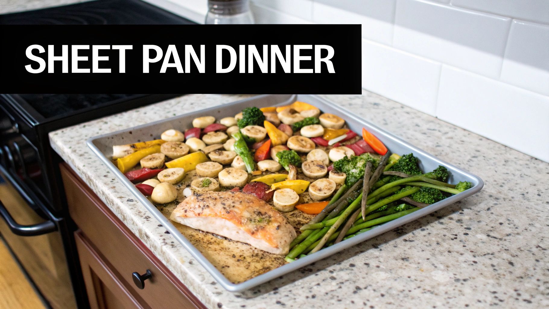 A delicious sheet pan dinner with roasted fish, broccoli, asparagus, and root vegetables on a kitchen counter.