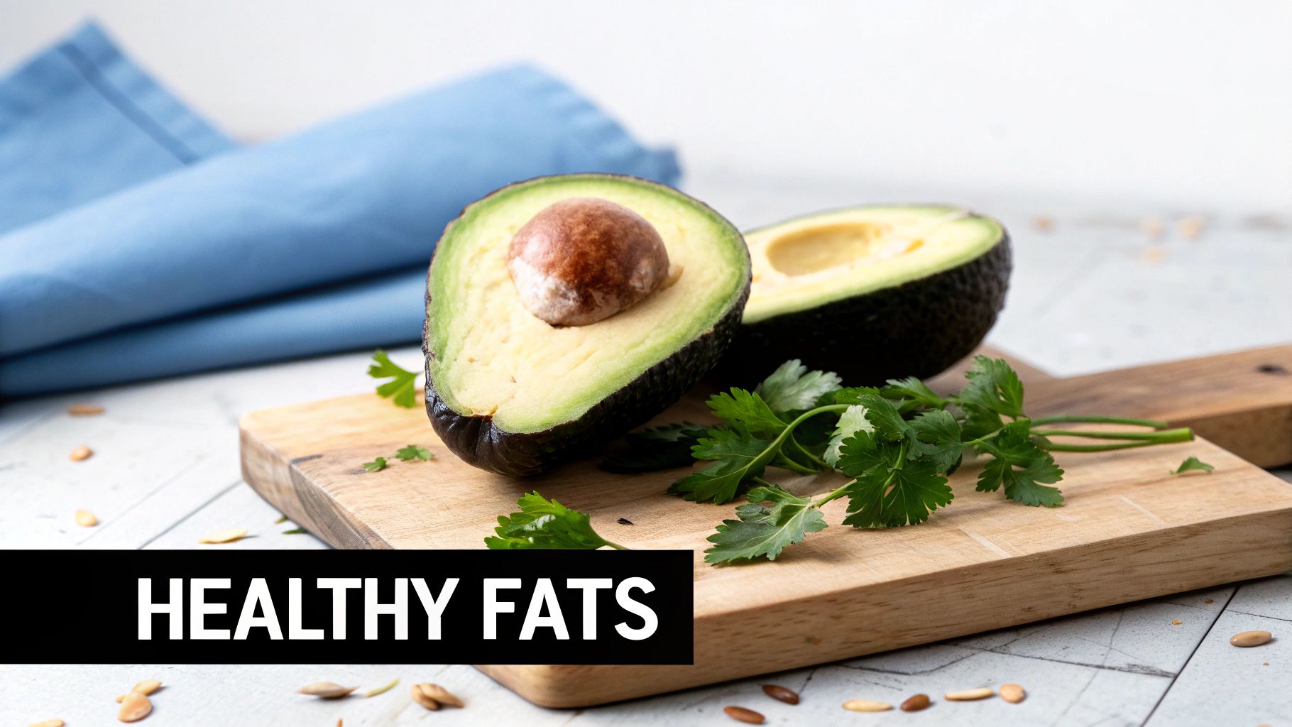 Two halves of a fresh avocado on a wooden cutting board with parsley, symbolizing healthy fats.