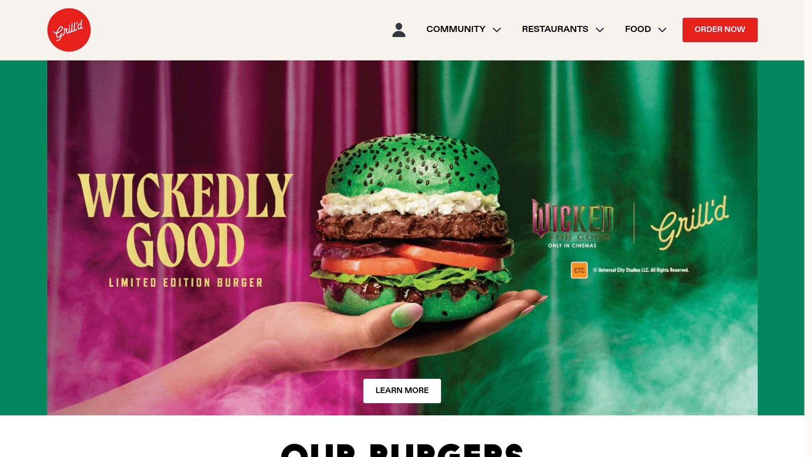 The Grill'd website homepage showing a close-up of a burger