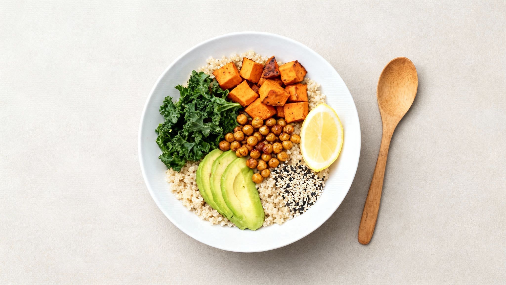 Healthy Buddha bowl with roasted sweet potato, chickpeas, avocado, kale and brown rice