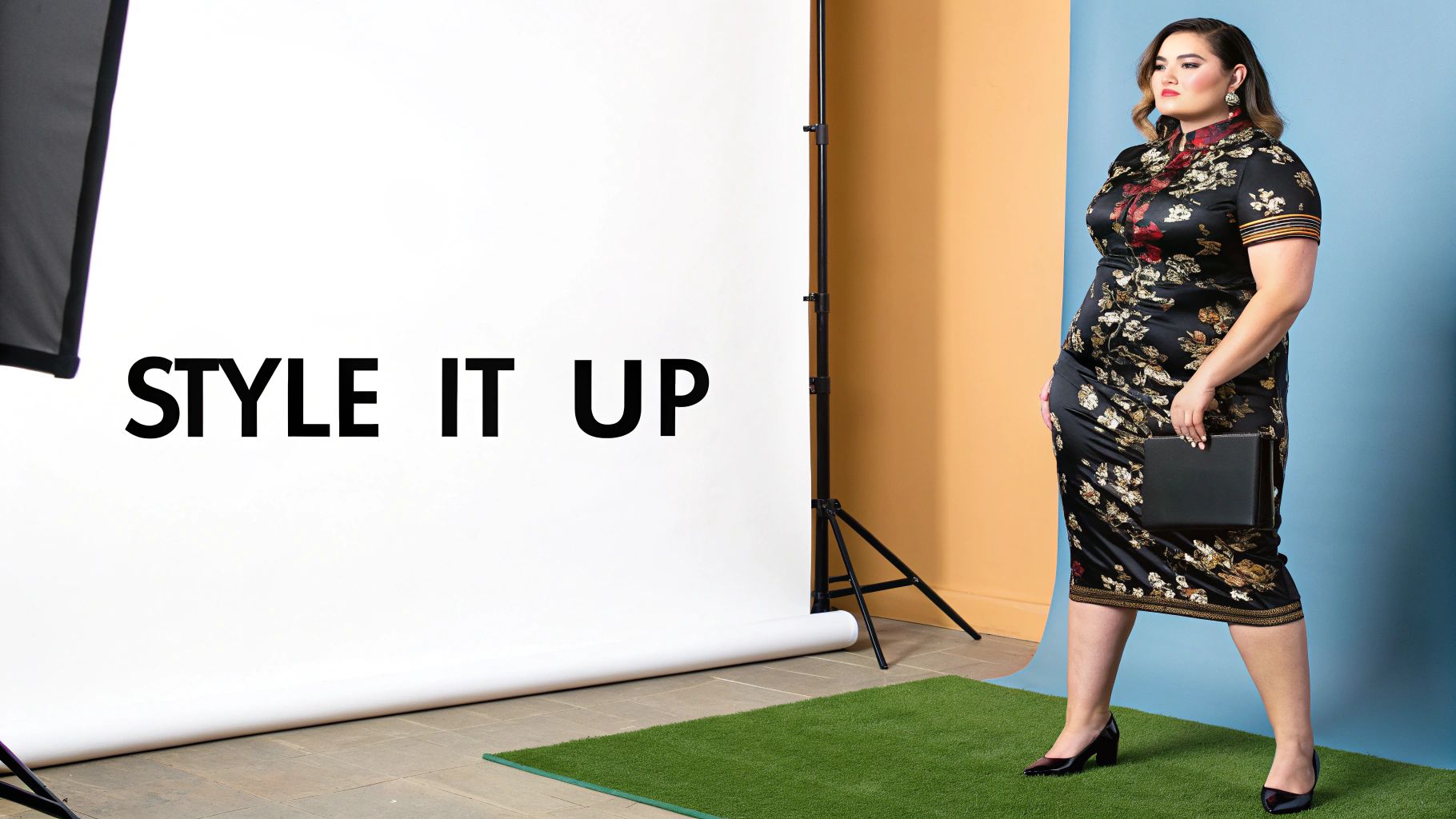 A stylish plus-size woman in a black floral cheongsam dress with a clutch poses in a studio.