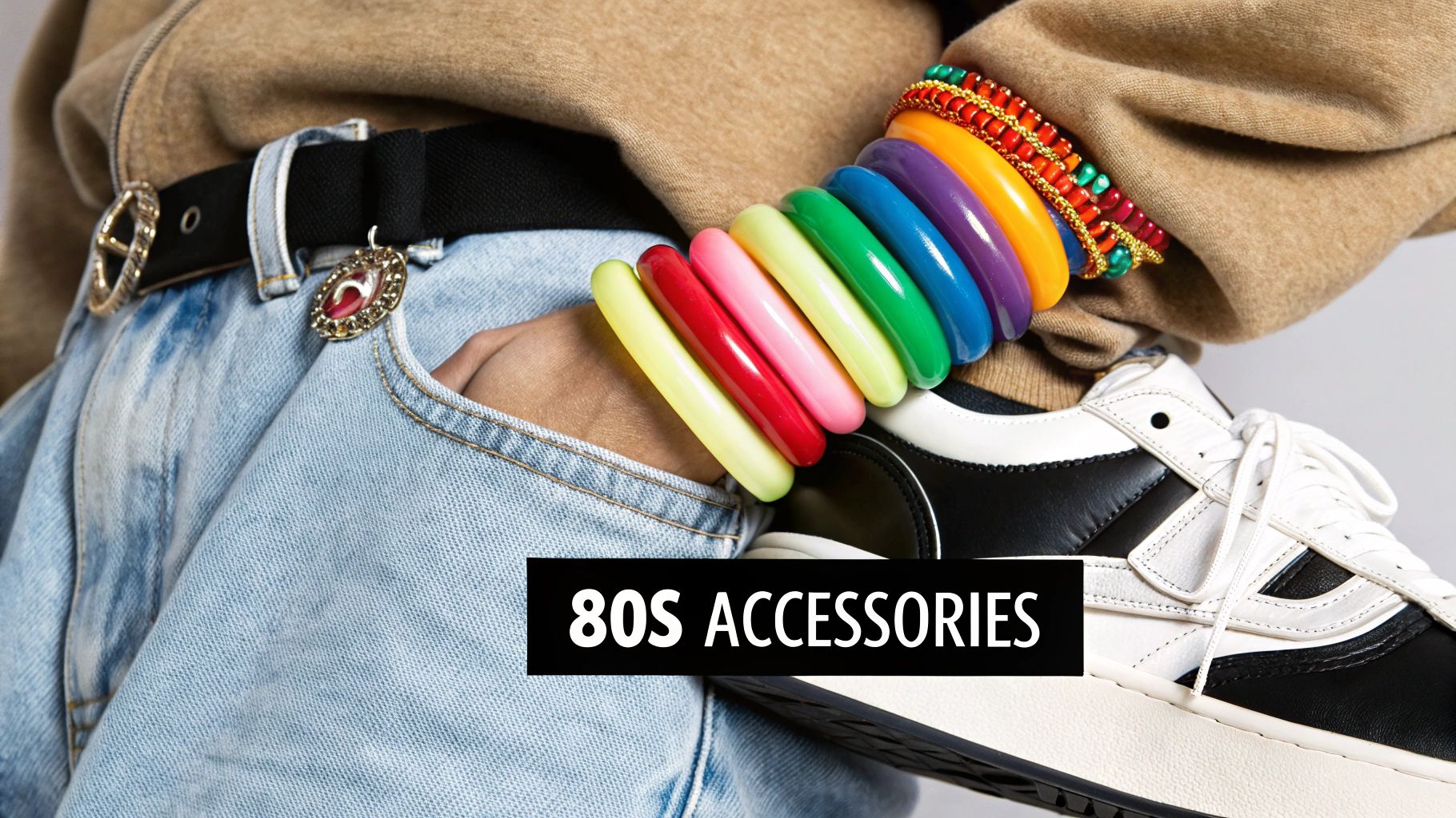 A person showing off 80s style accessories like colorful bracelets and a chunky belt.