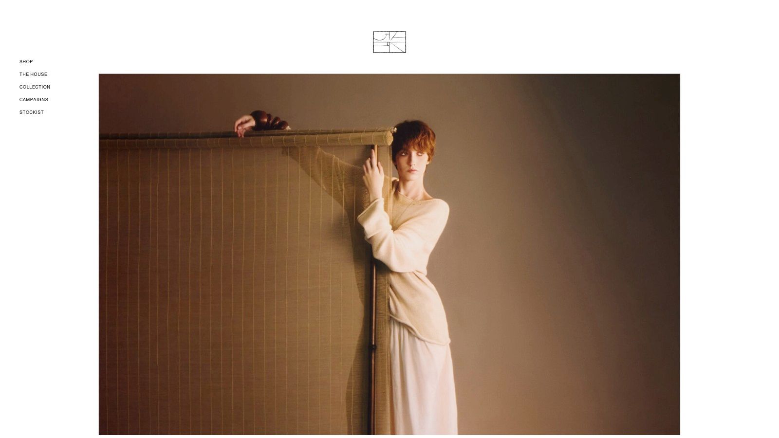 A fashion model wearing a sophisticated, minimalist black and white outfit from GIA STUDIOS, showcasing the brand's contemporary style.