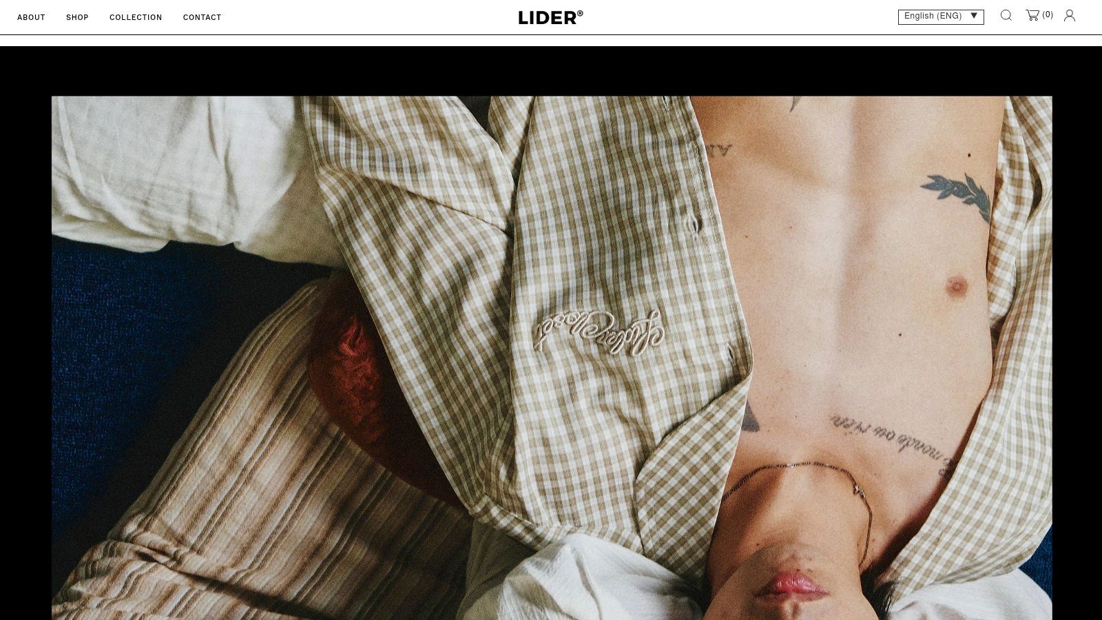 A male model wearing a black jacket and pants from the Vietnam fashion brand LIDER