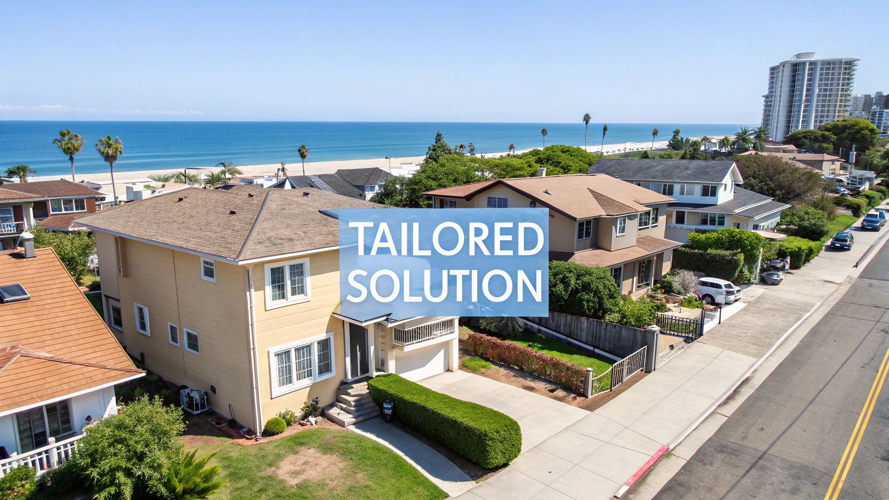 Aerial view of a coastal neighborhood with houses, a beach, and ocean, featuring 'TAILORED SOLUTION' text overlay.