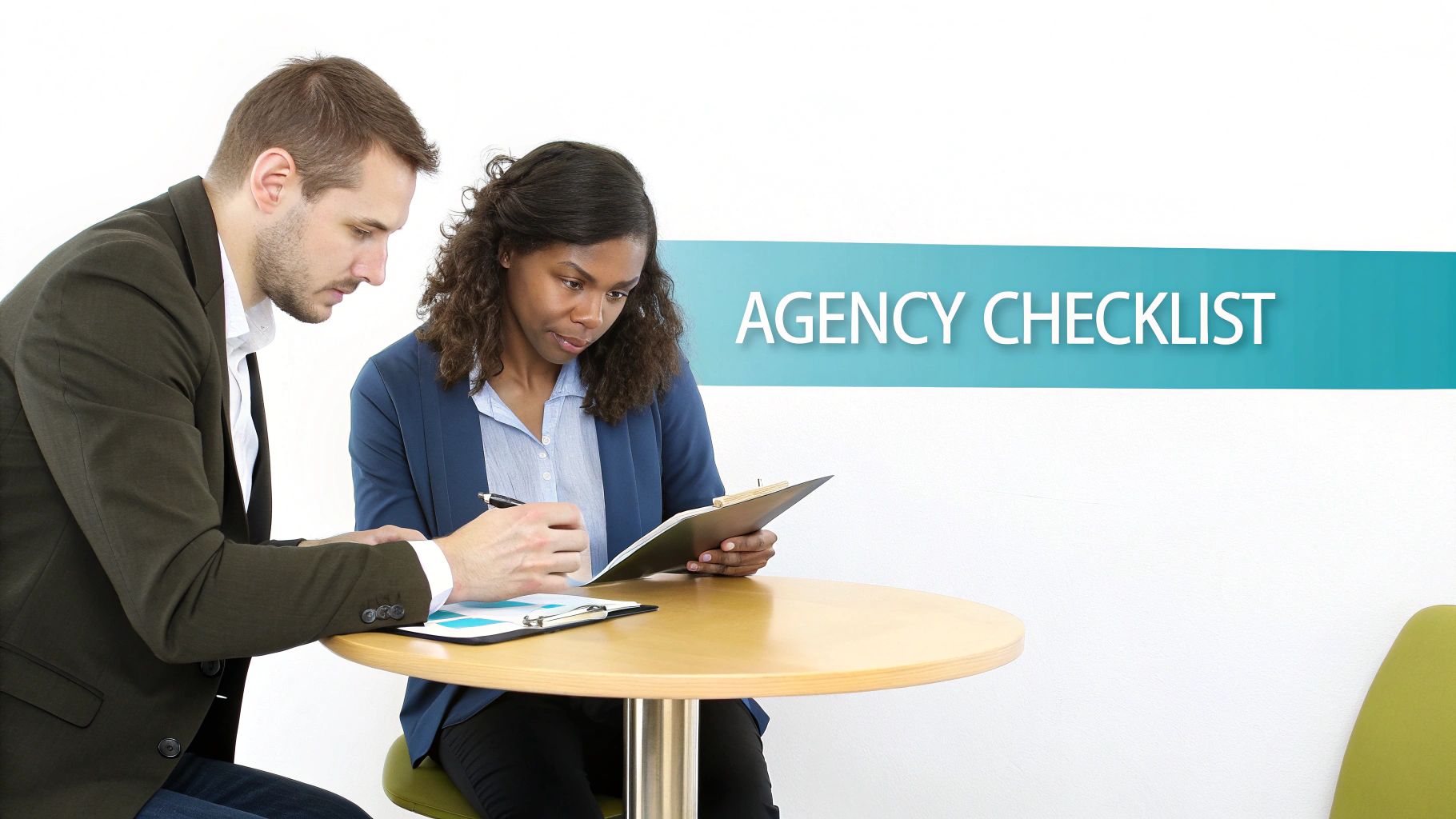 A man and a woman collaborating on a document, with an 'Agency Checklist' sign.