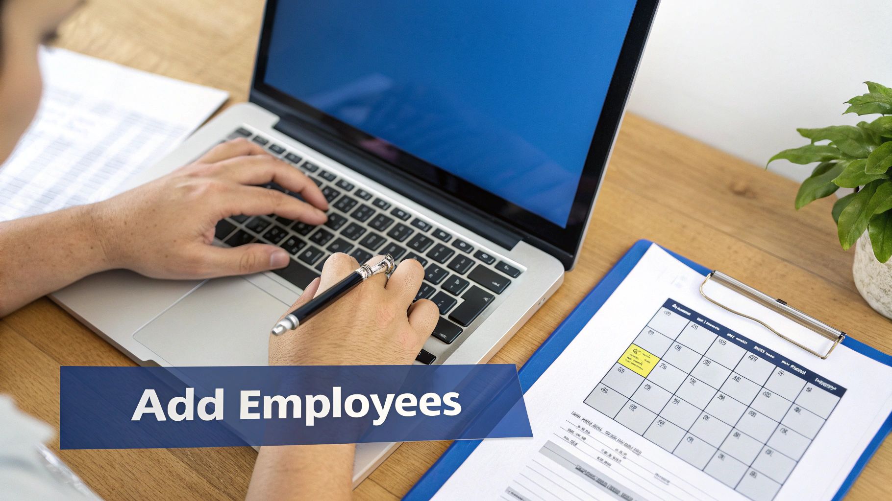 Person typing on a laptop, holding a pen, with documents and a plant, and 'Add Employees' text.