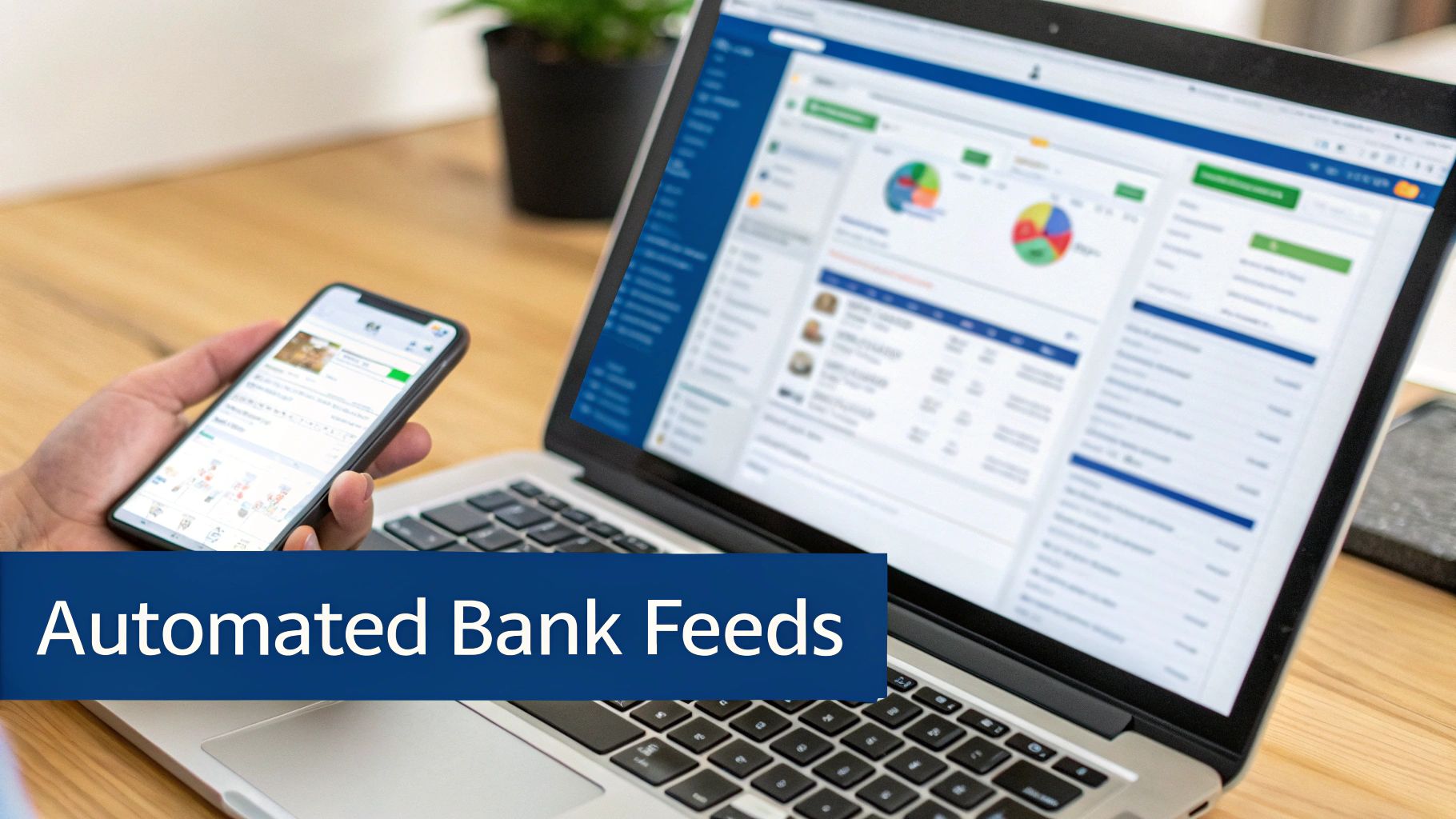 A person holds a smartphone displaying financial data next to a laptop showing automated bank feeds.