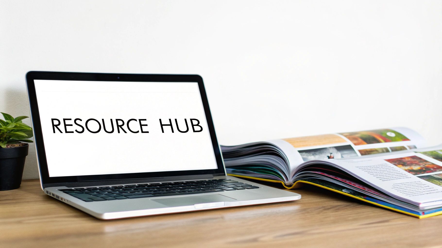 Laptop displaying 'RESOURCE HUB' on a wooden desk with an open magazine and a small plant, illustrating educational content strategy examples.