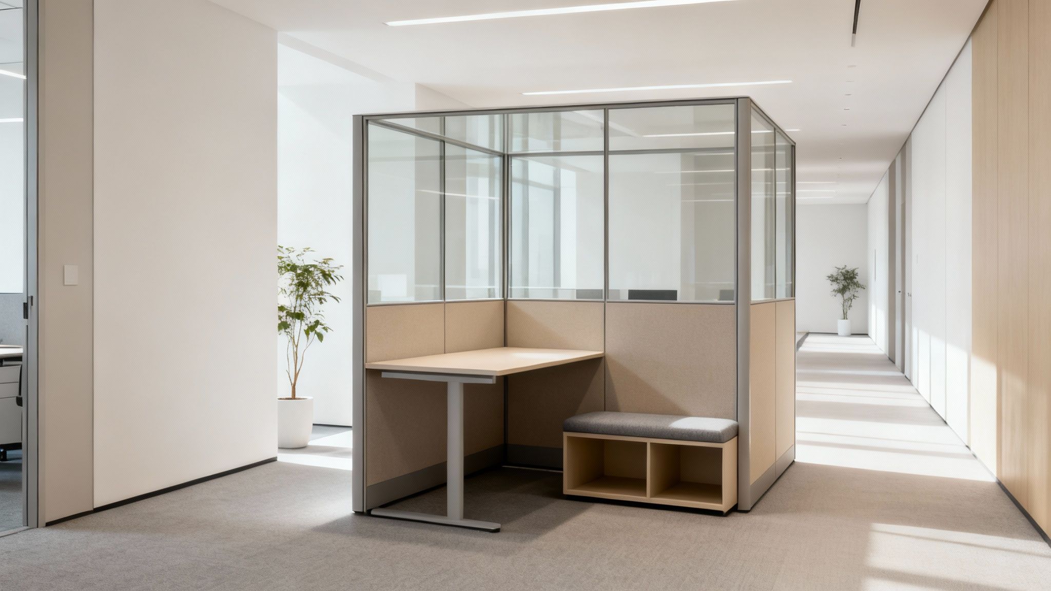 Bright, minimalist office corridor with a semi-enclosed work pod, desk, and storage bench.