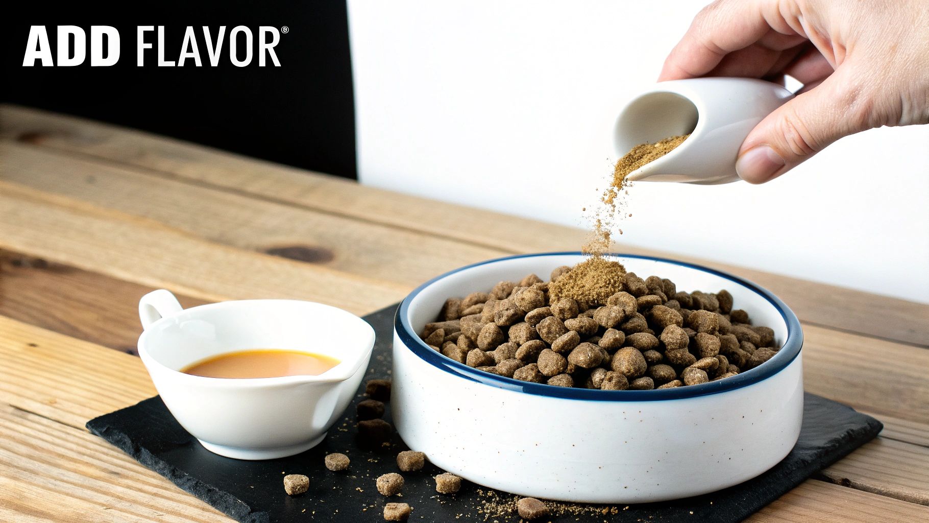 A hand pours flavor enhancer powder from a ChowPow bag onto dry dog food in a white bowl.