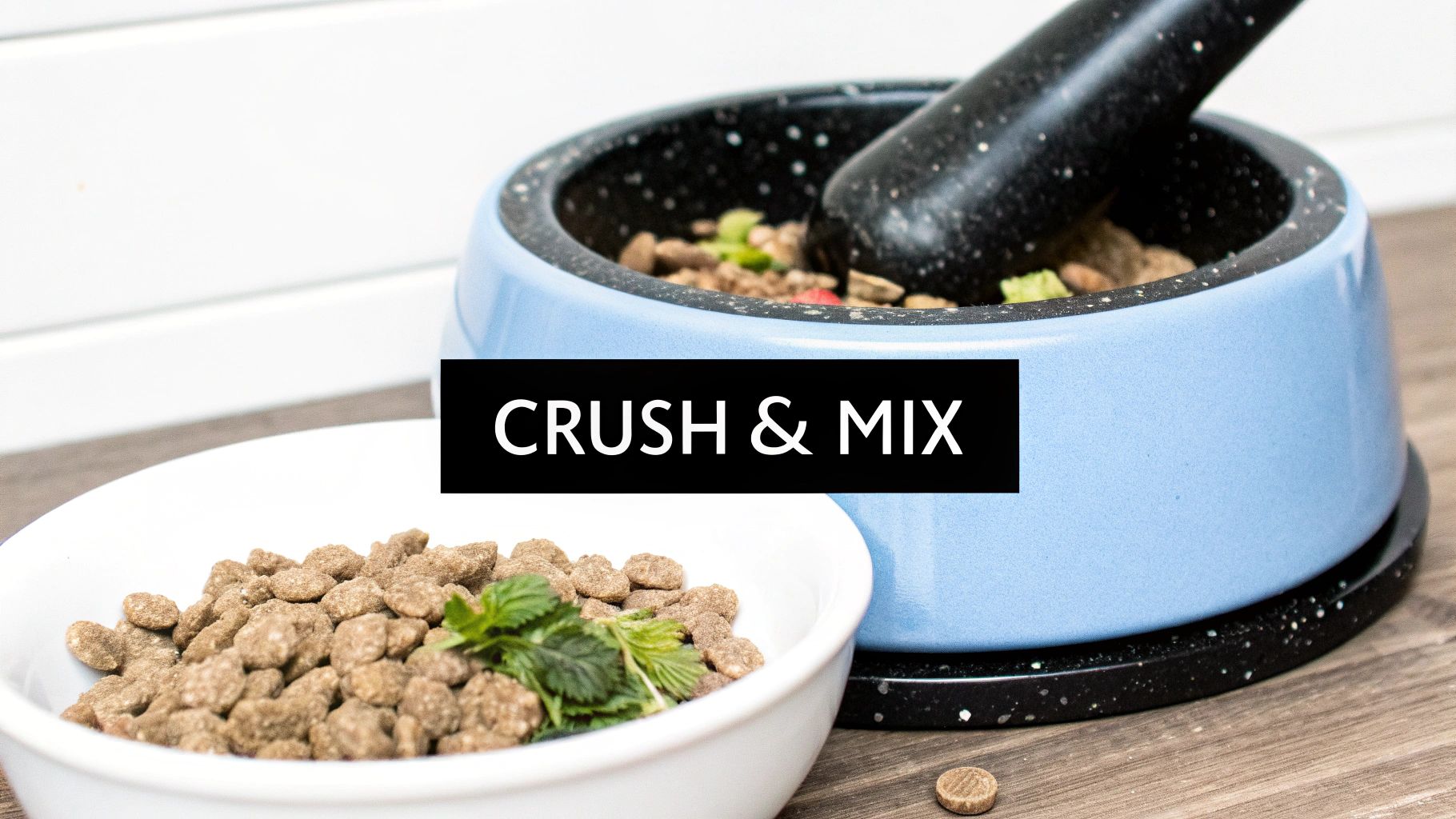Pet kibble in bowls, one with fresh herbs, and a mortar and pestle to crush food.