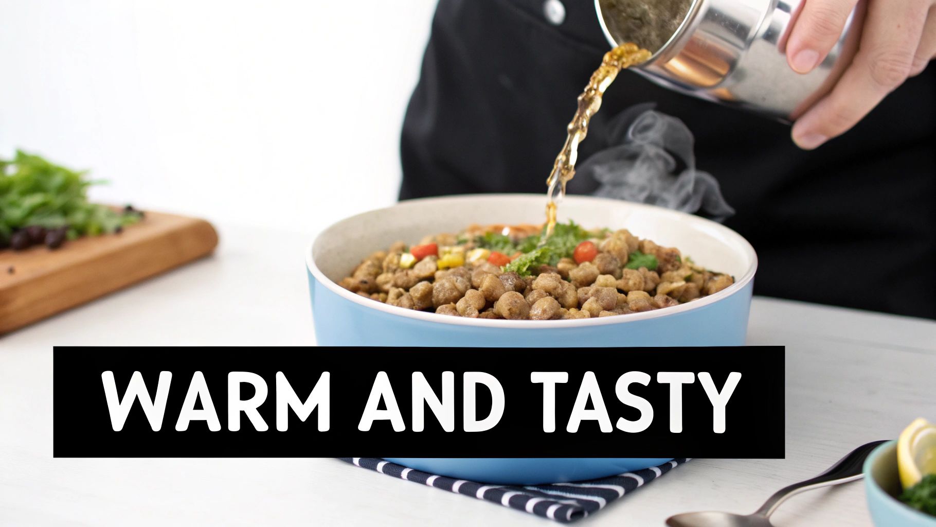 A person pours warm liquid into a steaming bowl of food, garnished with herbs and vegetables.