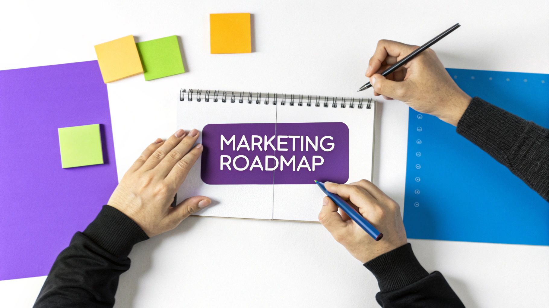 Two people collaborating on marketing roadmap strategy planning with colorful sticky notes and notebook