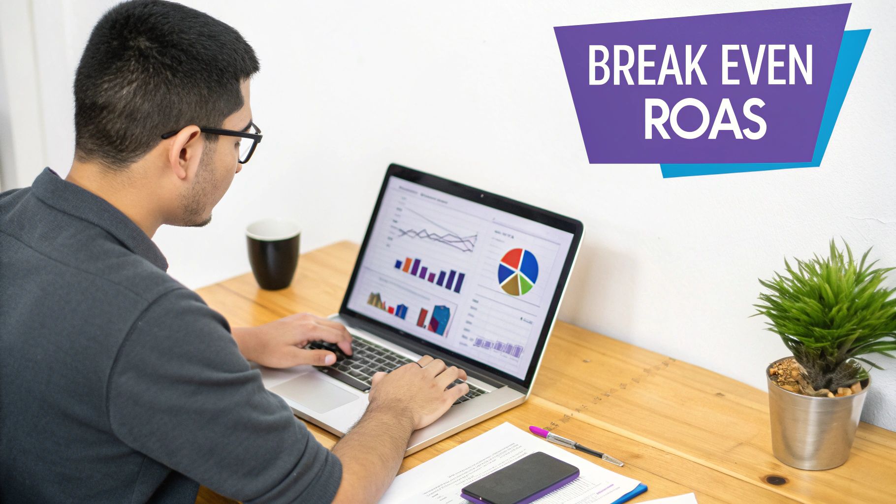 A man analyzes financial data on a laptop, with "BREAK EVEN ROAS" prominently displayed on a purple banner.