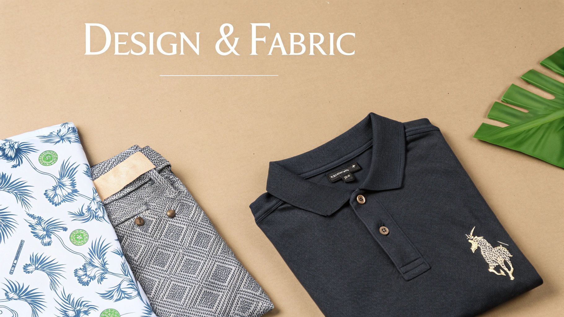 Close-up of various fabrics, including a black polo shirt with a gold embroidered unicorn and patterned textiles.