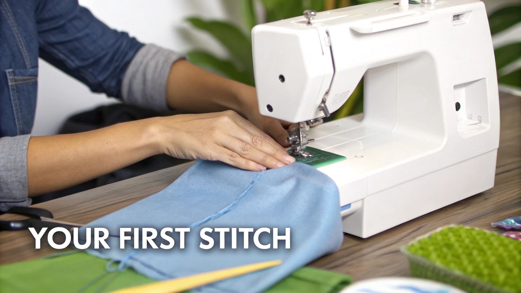A person operates a white sewing machine, carefully guiding light blue fabric to create their first stitch.