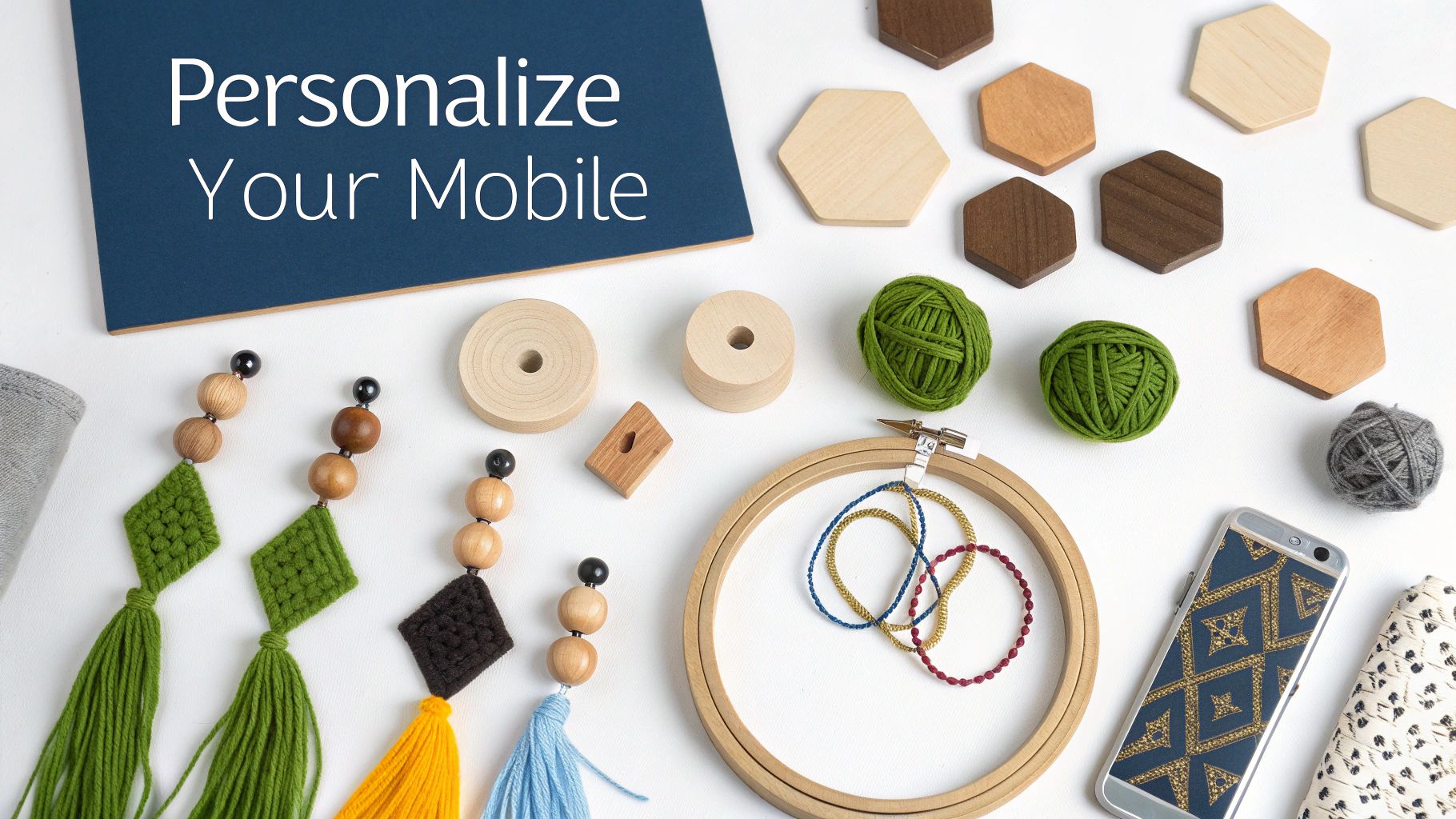 Crafting supplies laid out, including yarn, wooden beads, and shapes, for personalizing a mobile.