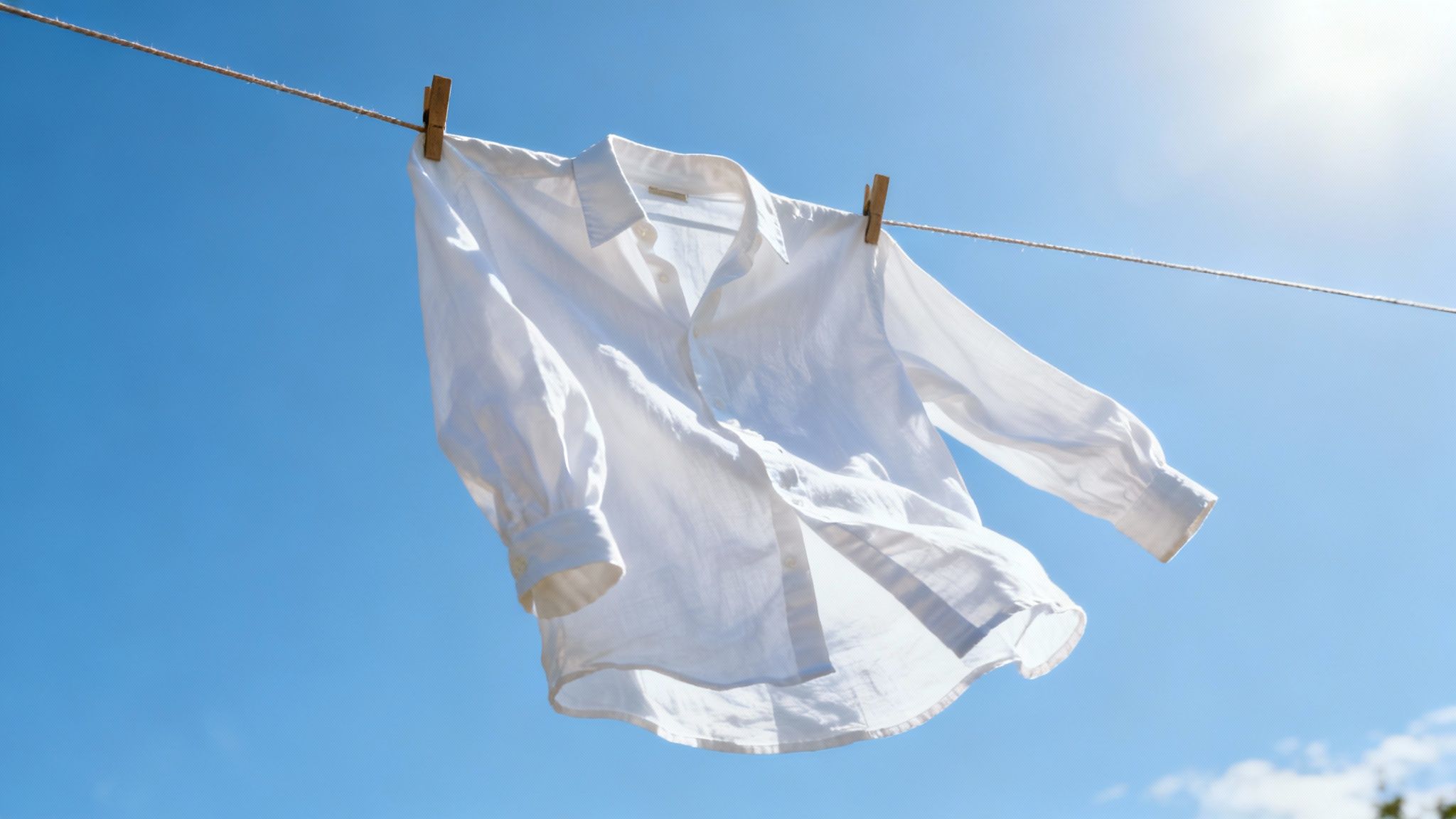 Sunlight shining on clean clothes hanging on a clothesline