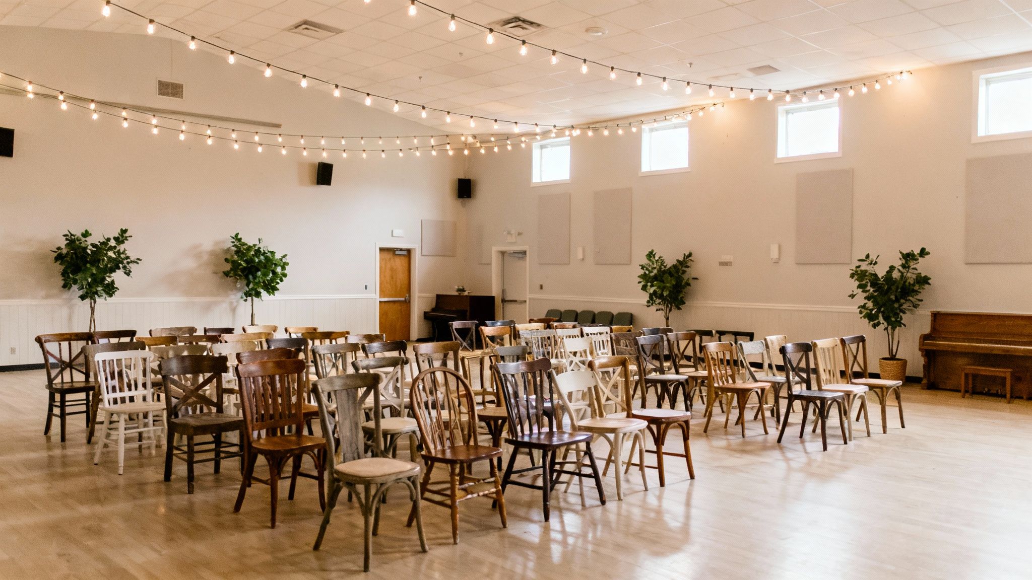 A couple toasts at their wedding reception in a beautifully decorated venue.
