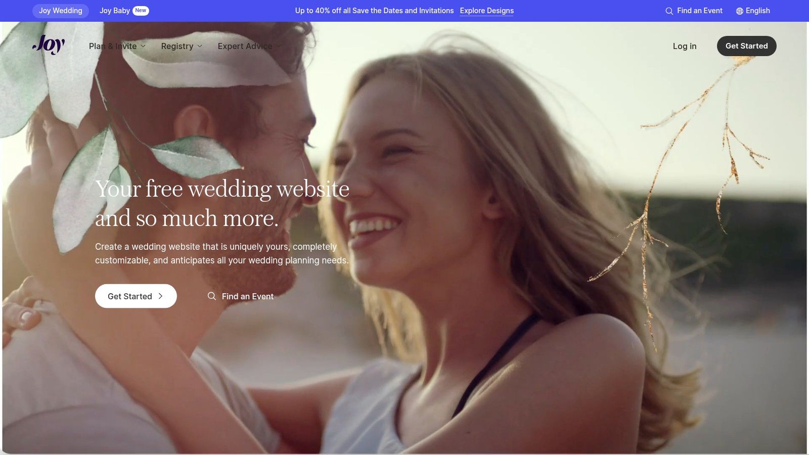 A smiling wedding couple looking at each other, used as an example on the Joy wedding website platform.