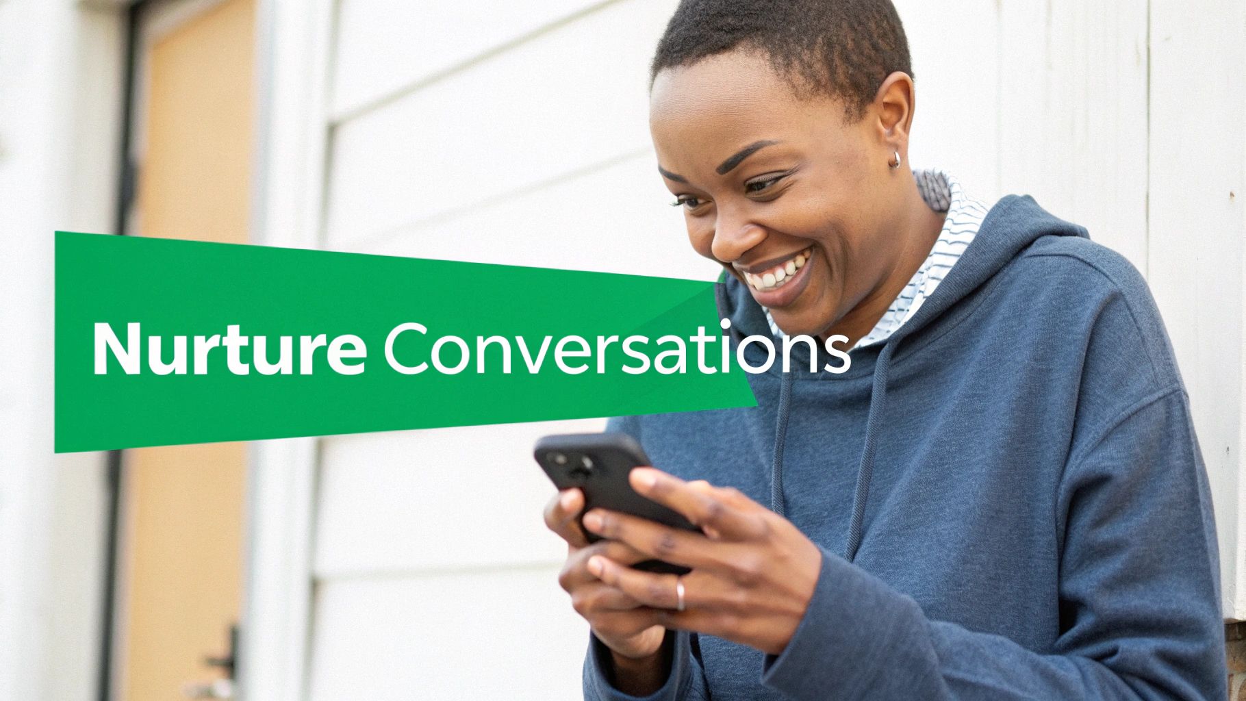 A happy Black woman smiles while looking at her smartphone with the text 