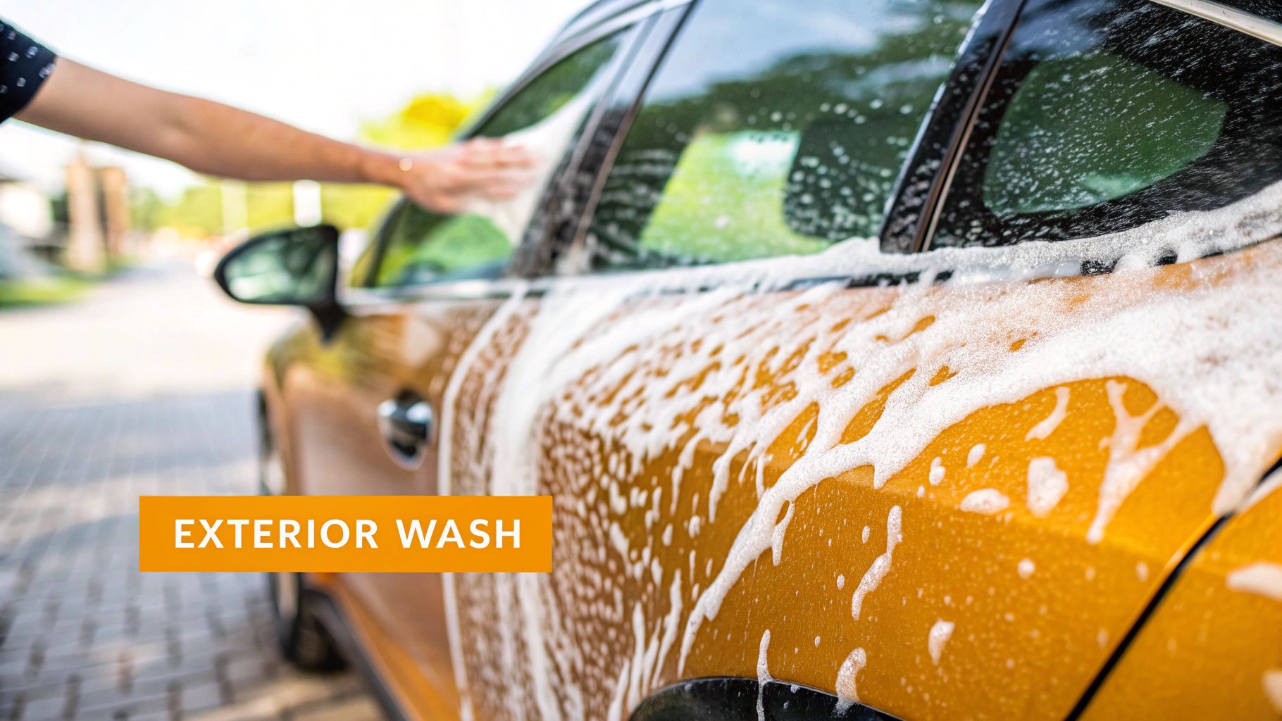 A collection of basic car detailing supplies including a foam gun, buckets, and microfiber towels.