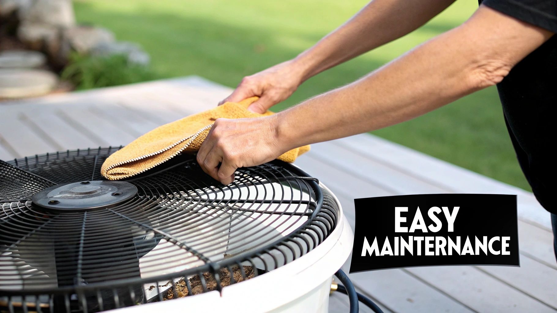 A person cleaning the blades of a white outdoor table fan with a cloth.