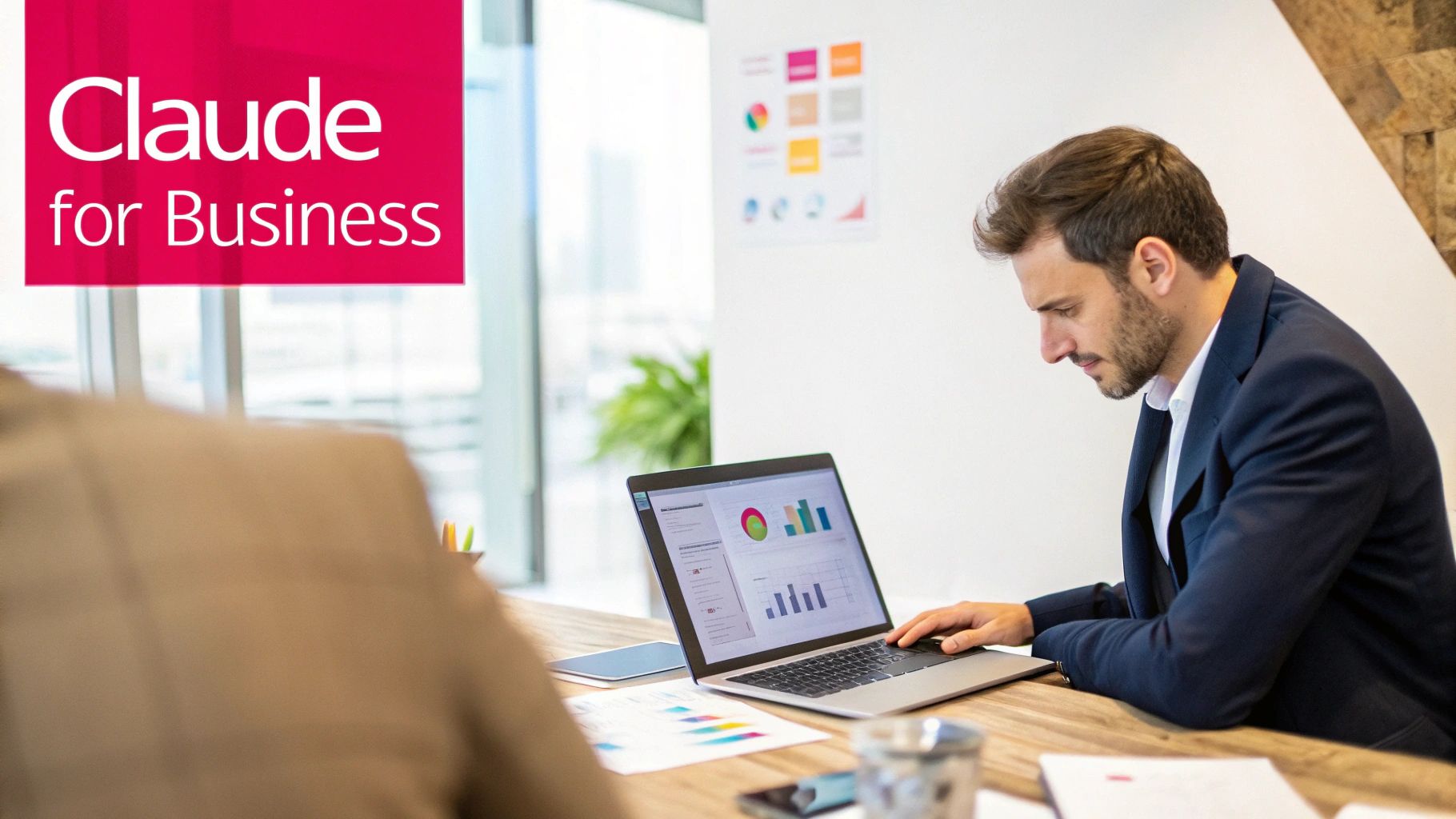 A man in a business suit works on a laptop displaying data charts, with 'Claude for Business' branding.