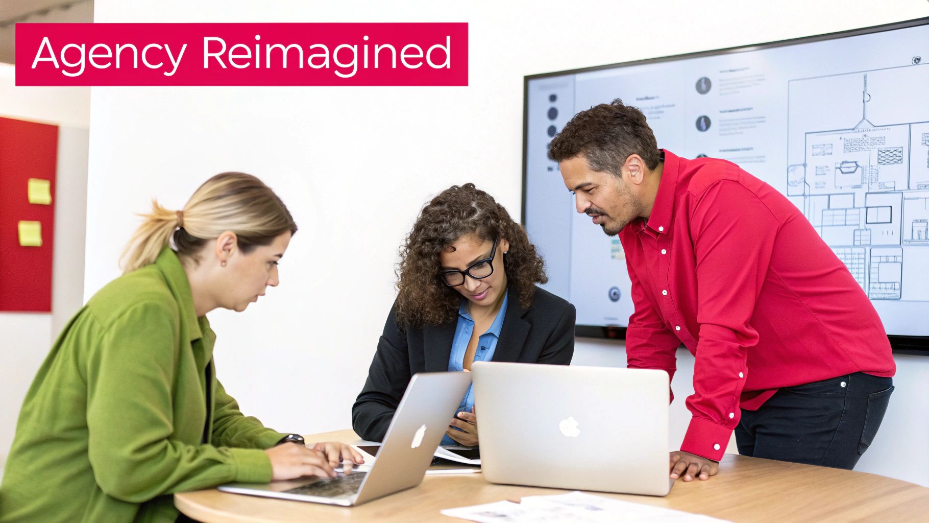 Three colleagues collaborate around laptops and a large screen in a modern office, reimagining agency strategies.