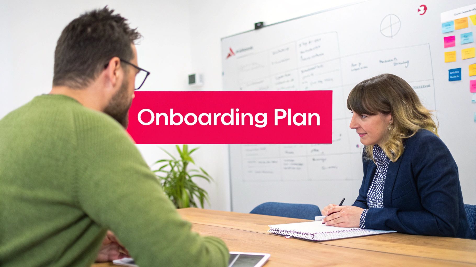 Two professionals discussing an onboarding plan in a bright office meeting room.