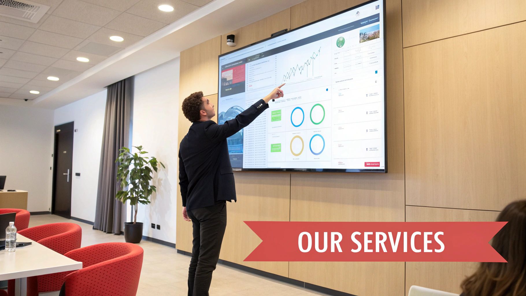 man pointing at large screen 