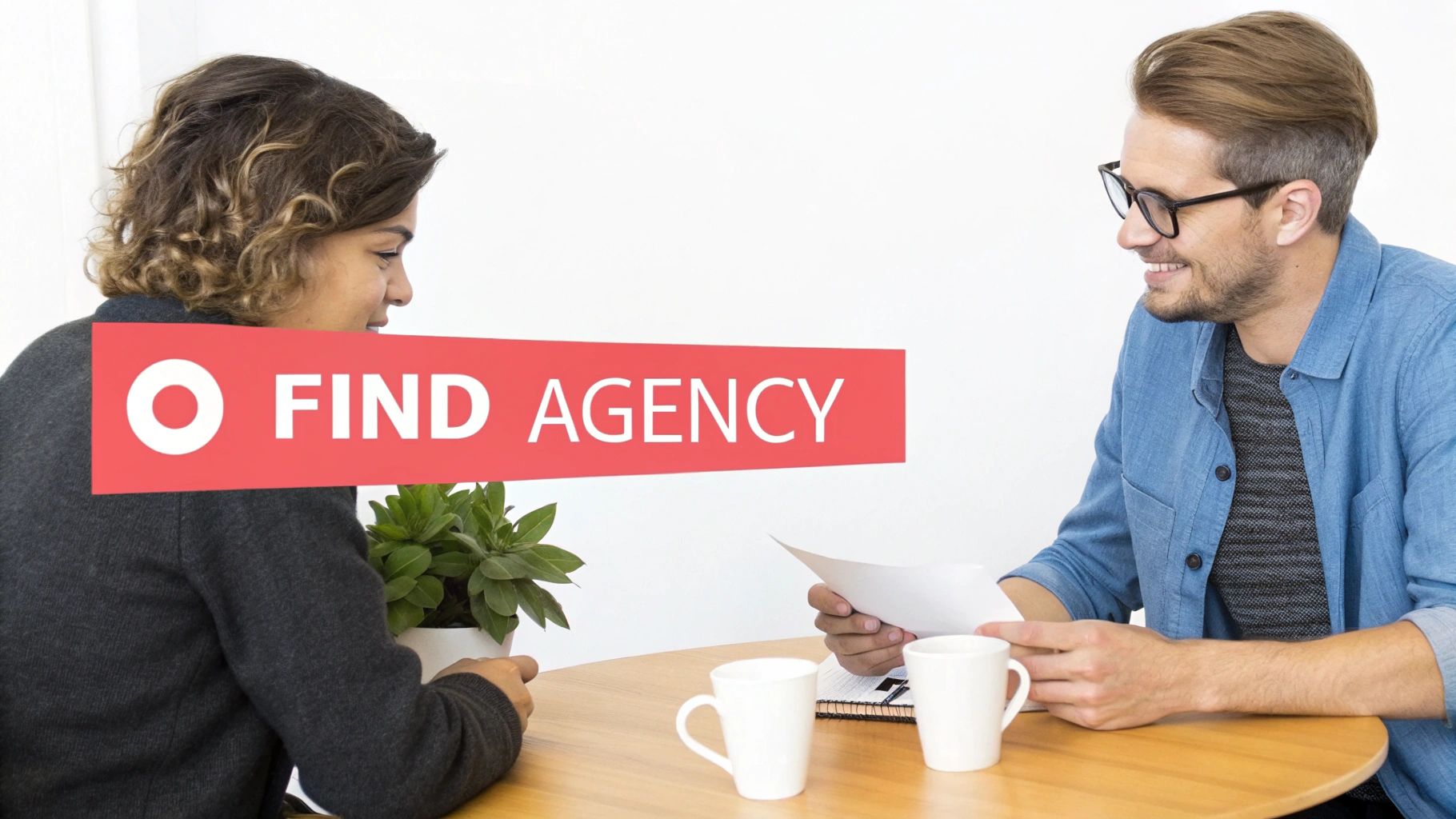 Woman and man at a table, discussing documents. Red 
