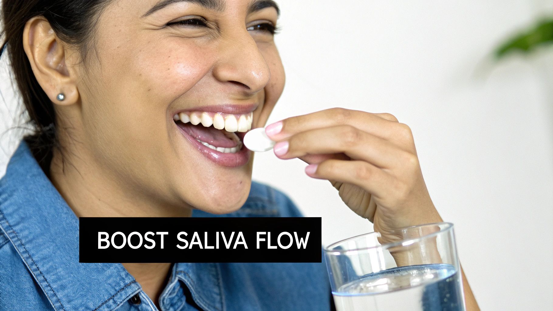 Smiling woman taking white pill with water to boost saliva flow for oral health