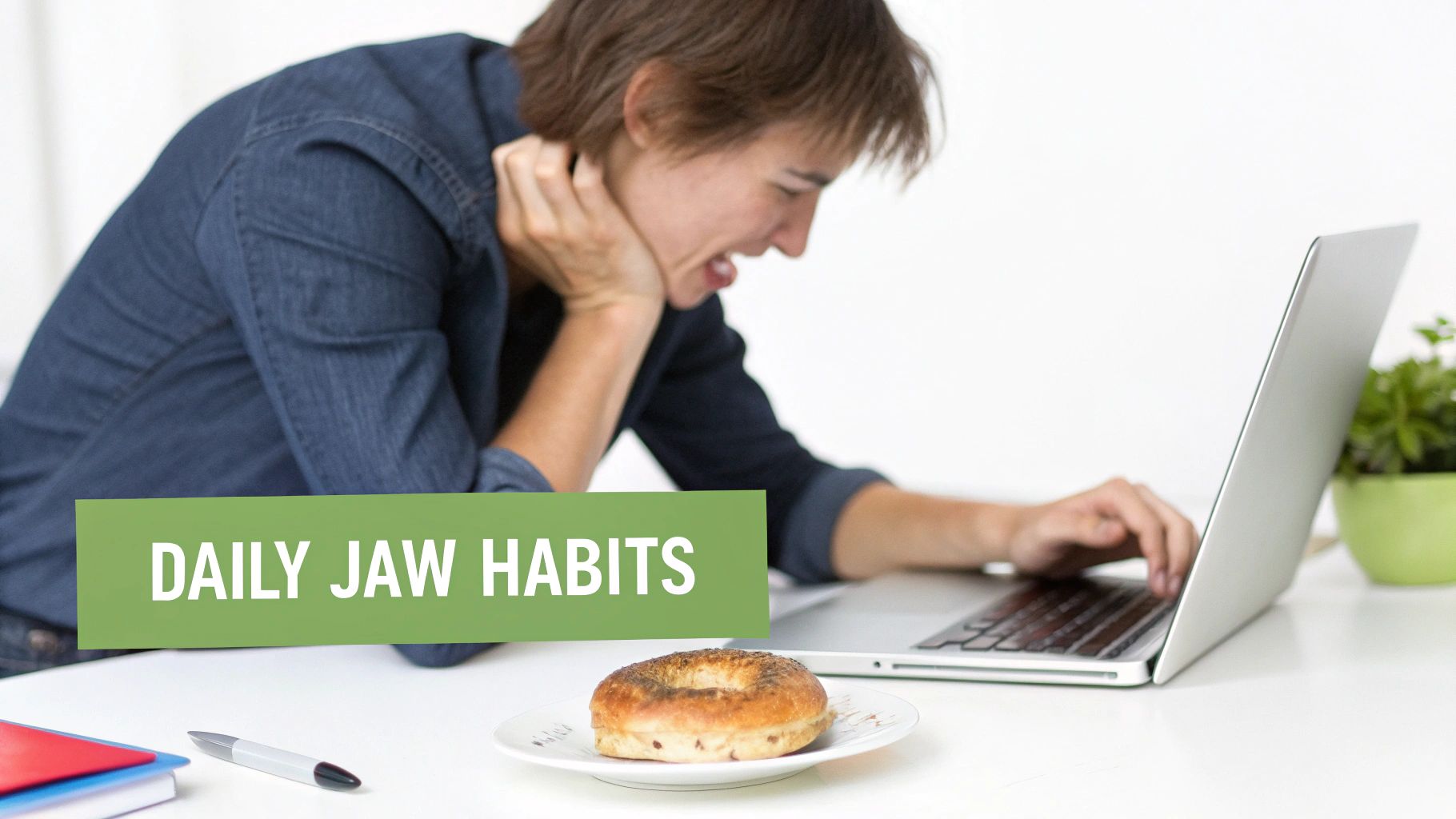 Stressed person with jaw pain clutching neck while working on a laptop, highlighting daily jaw habits.