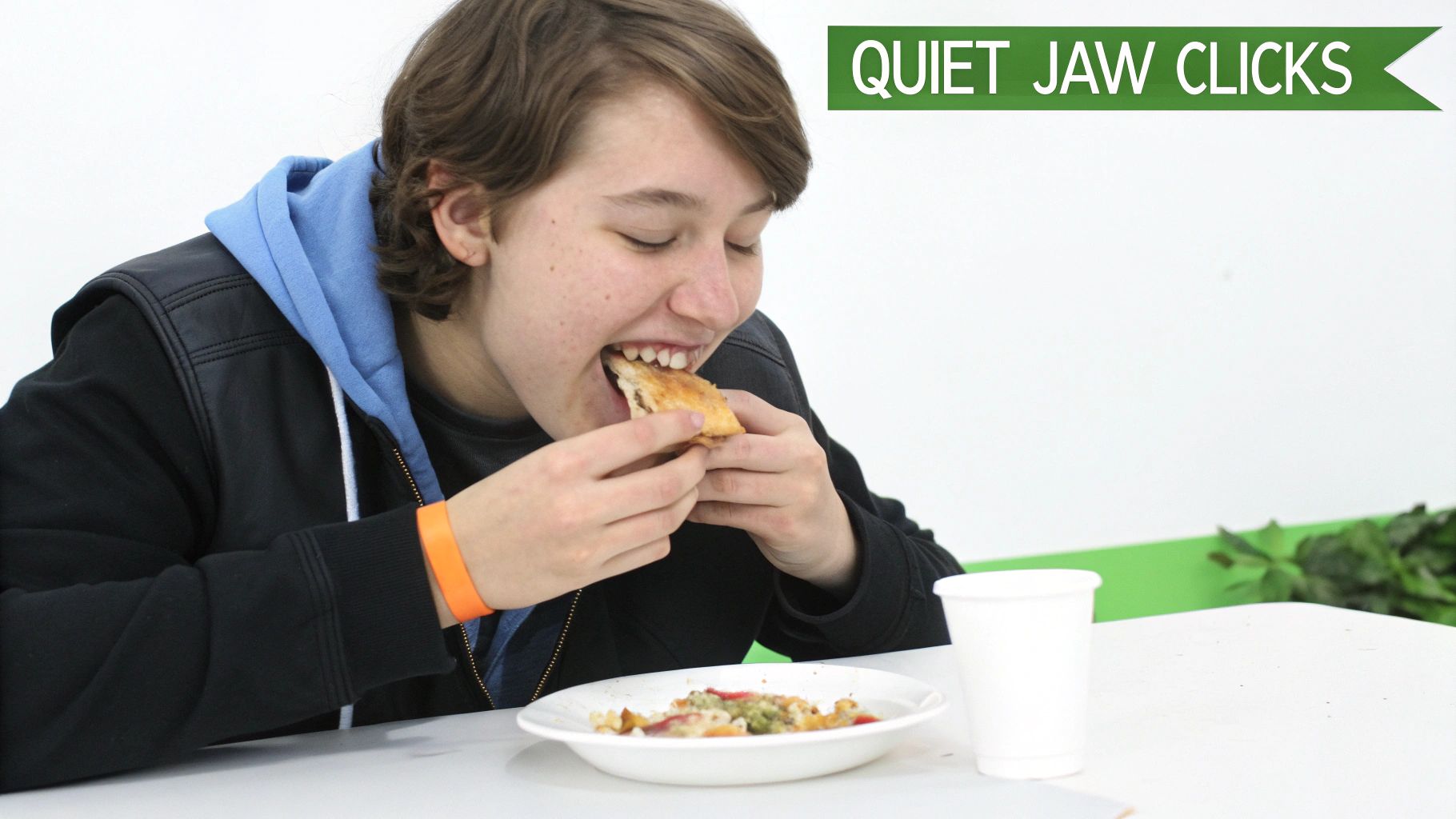 A young person happily eats a pastry, wearing a black jacket and blue hoodie, with a 'QUIET JAW CLICKS' banner.