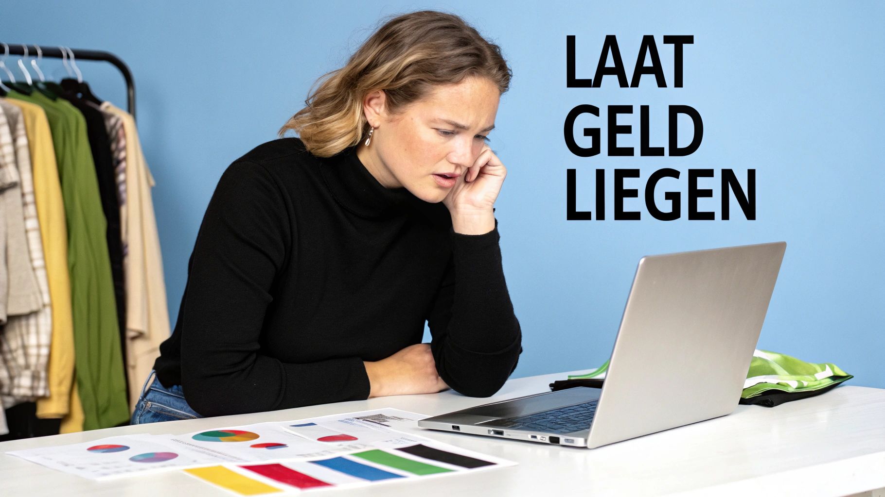Vrouw kijkt geconcentreerd naar laptop met financiële grafieken en een kledingrek op de achtergrond.