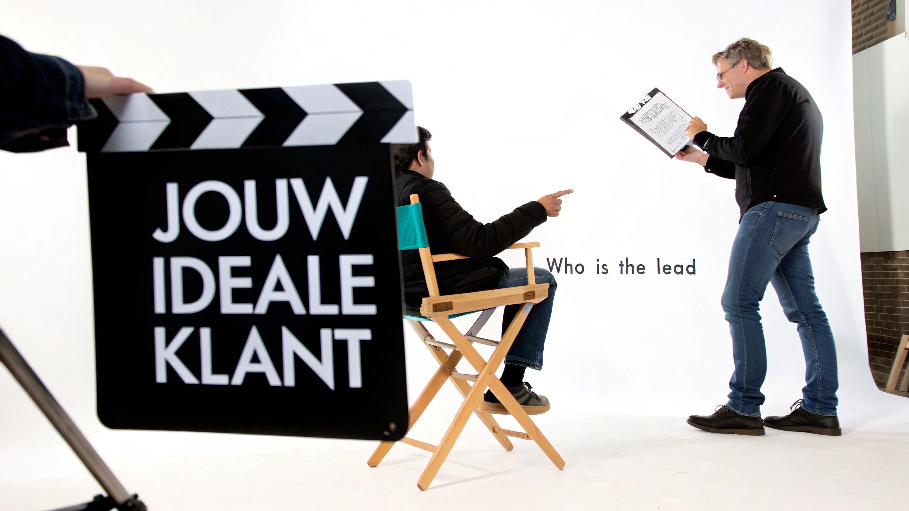 Mannen op een filmset met een clapperboard waarop 'Jouw Ideale Klant' staat, en een man wijst.