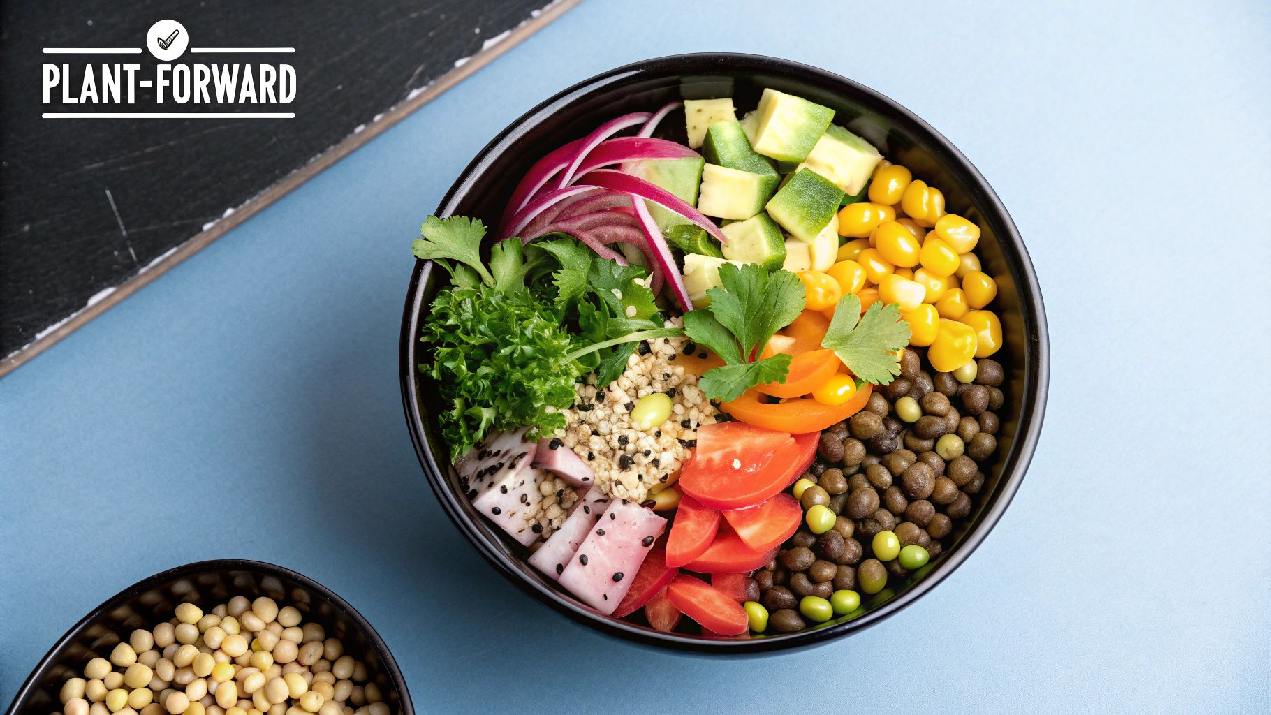 A colorful bowl of plant-based foods including chickpeas, quinoa, and fresh vegetables.
