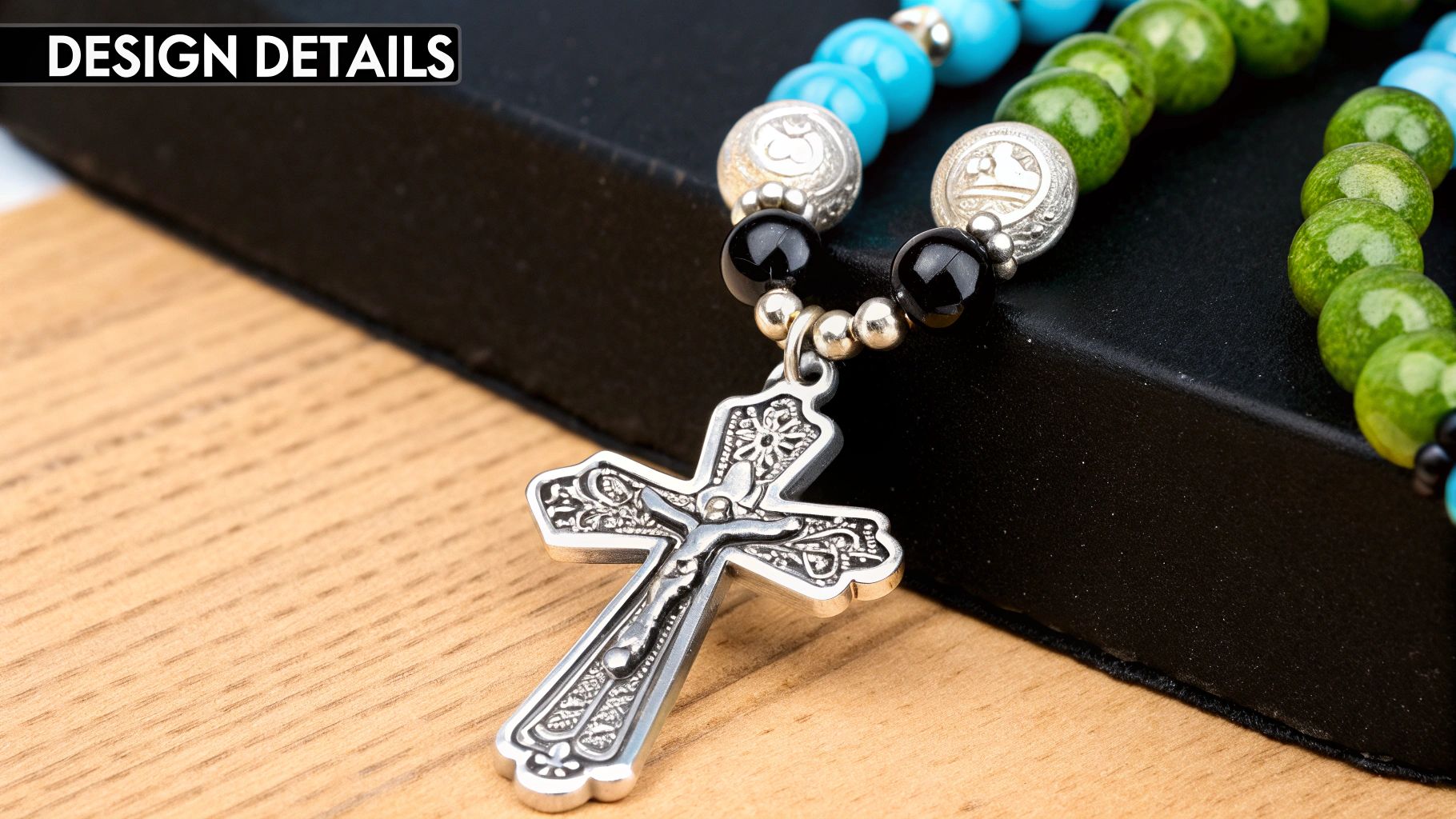 A close-up of a turquoise cross necklace against a neutral background
