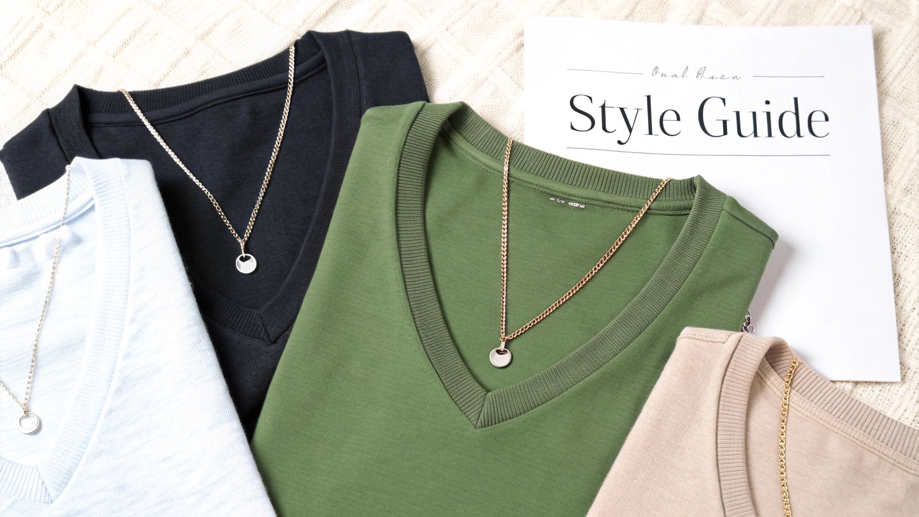 Four V-neck t-shirts in light blue, black, green, and beige, each with a delicate necklace, next to a style guide.