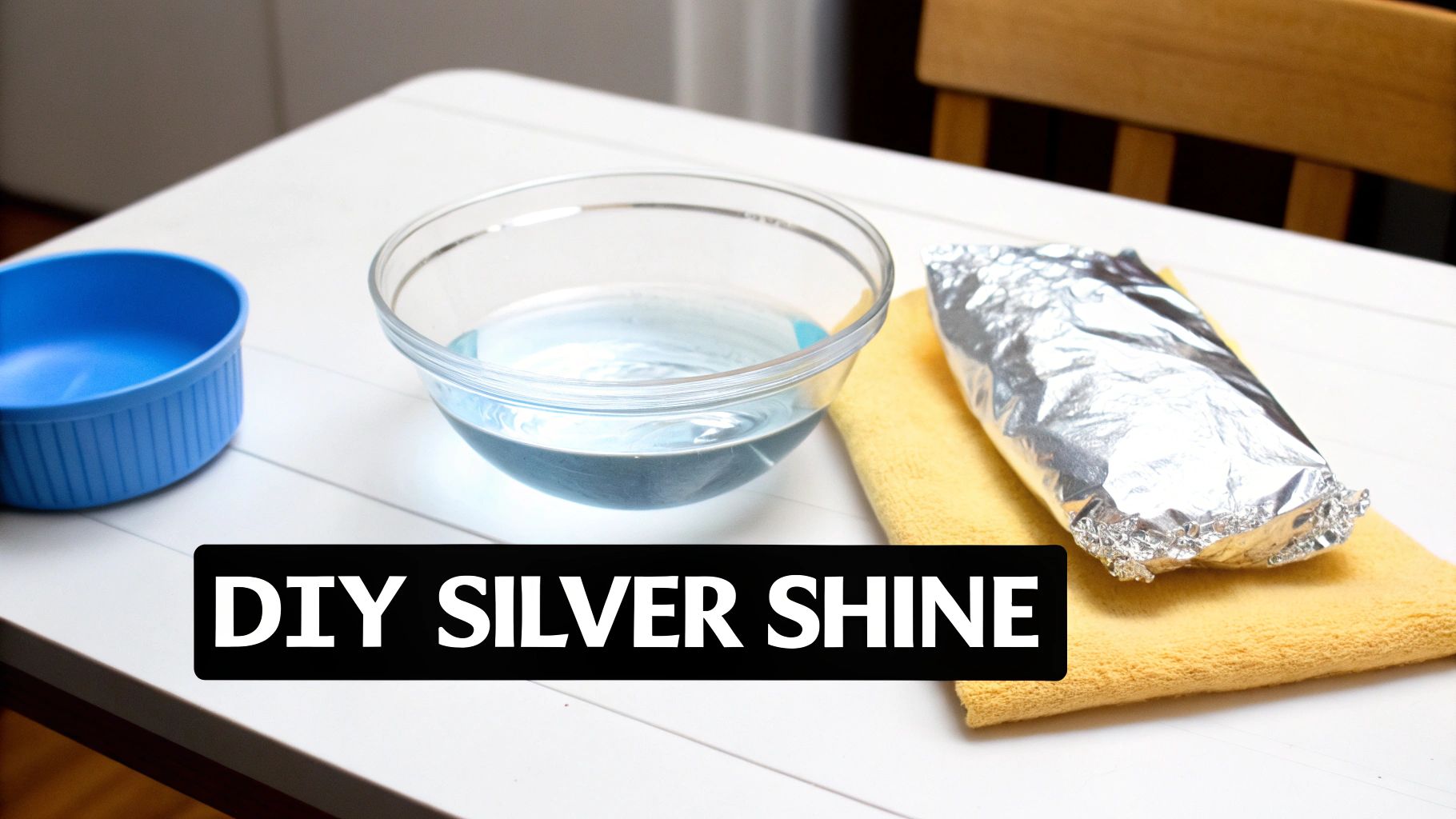 A hand gently cleaning a silver necklace with a soft cloth.