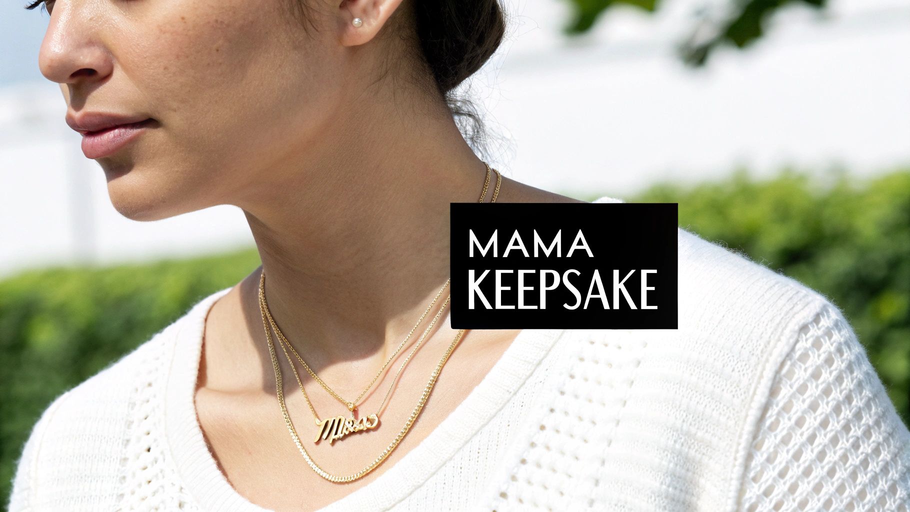 A woman wearing a delicate gold mama necklace, showcasing its elegant style.