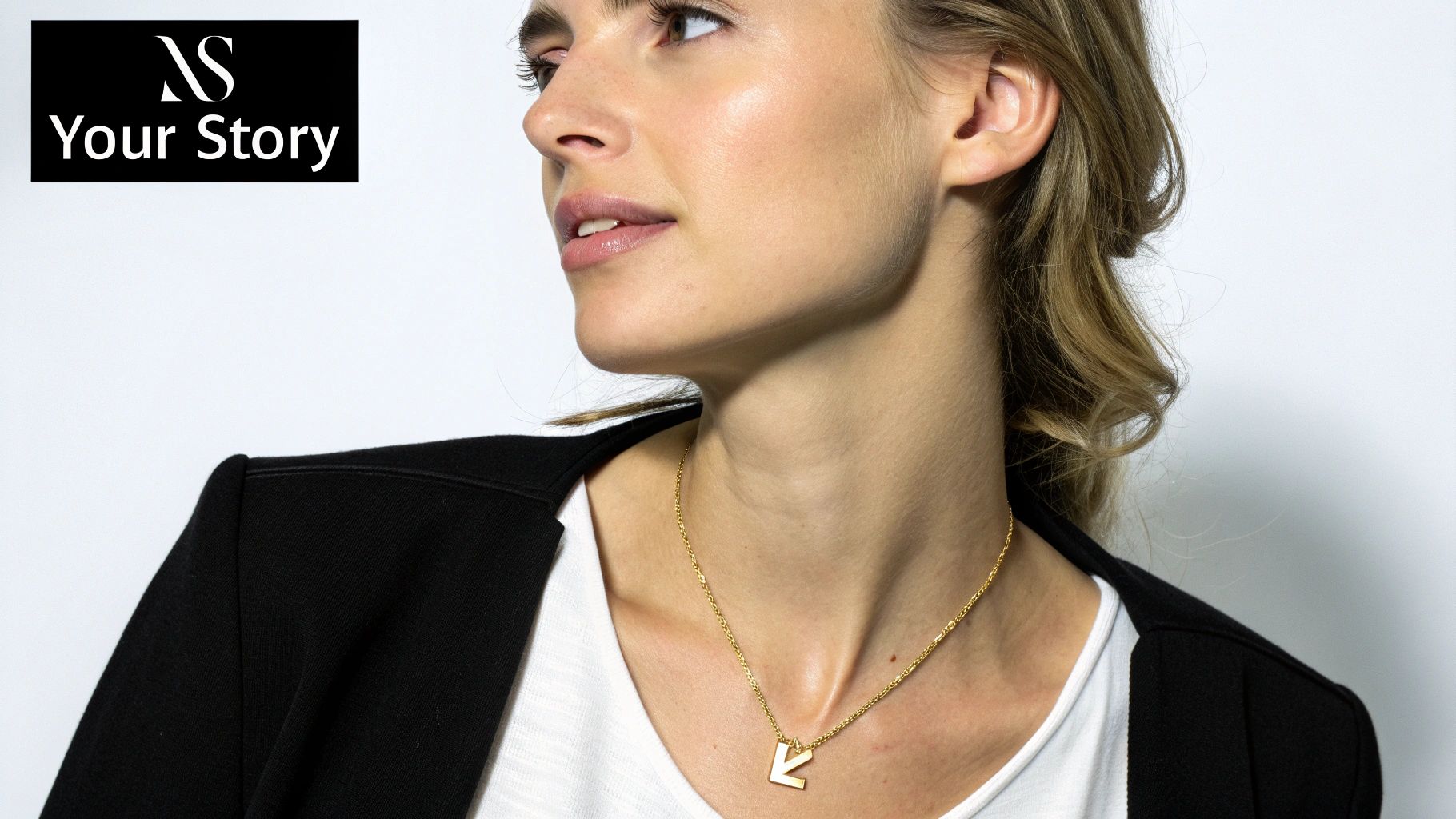 A woman wearing a gold custom letter necklace.